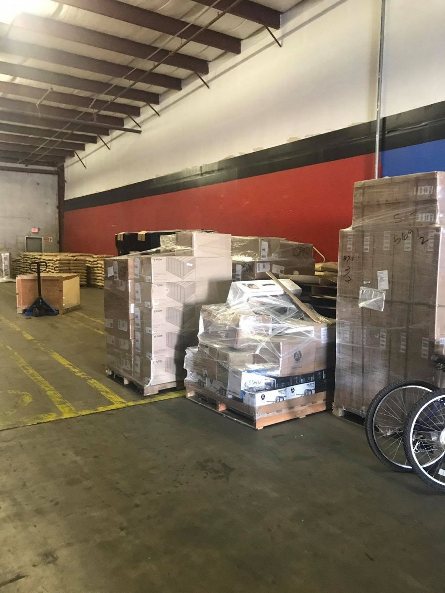 Shrink-wrapped pallets of boxed merchandise waiting on the warehouse floor