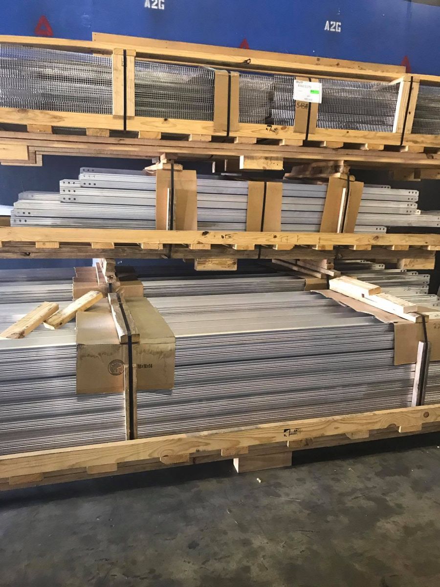 Crated aluminum profiles stacked on wooden pallets